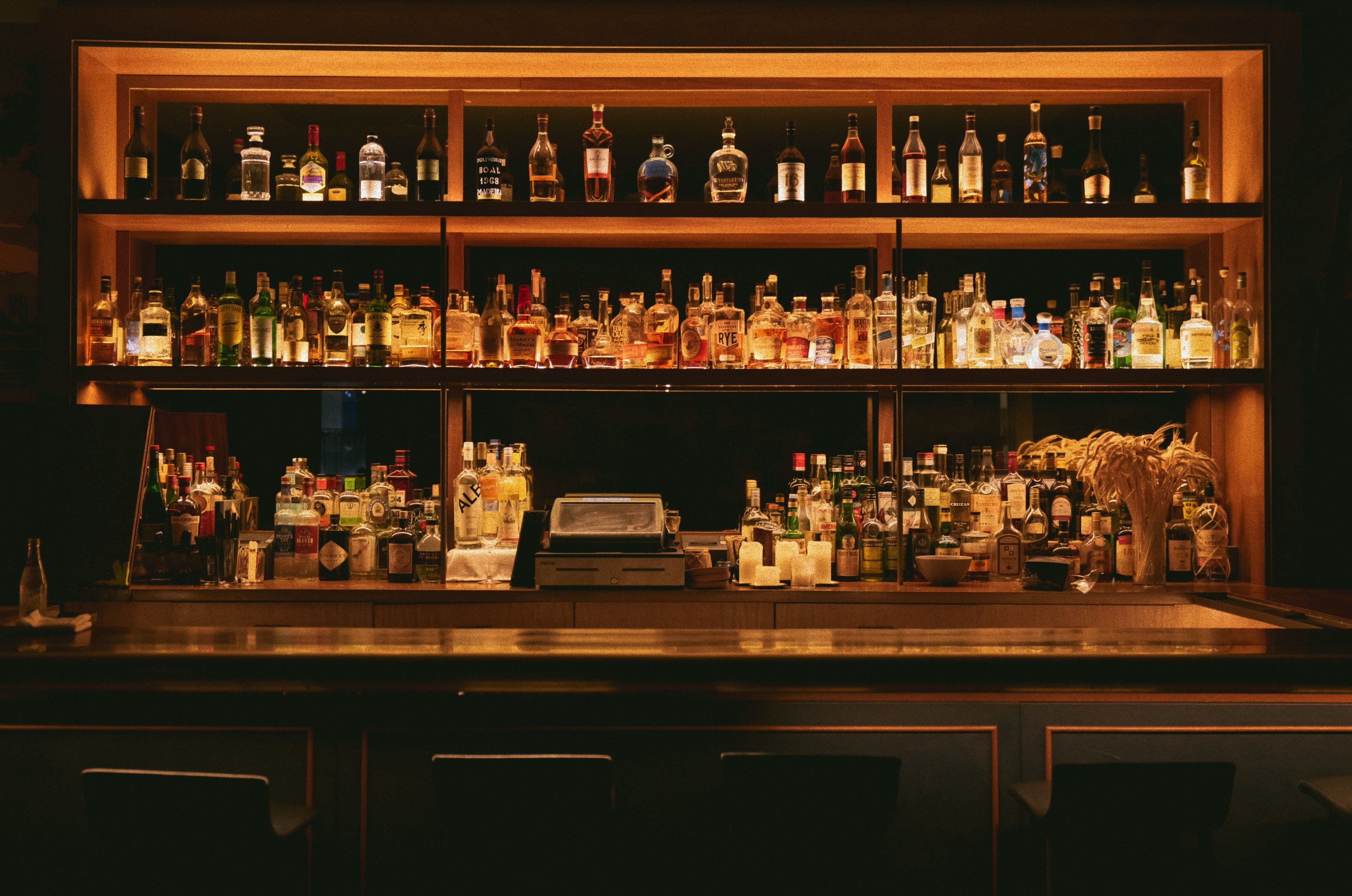 Back bar with illuminated shelves of bottles
